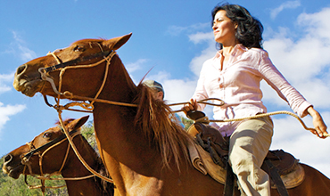 Cuban woman riding horse.